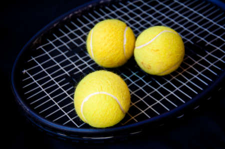 tennis ball on racketの写真素材