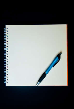 pen and notebook on black backgroundの写真素材
