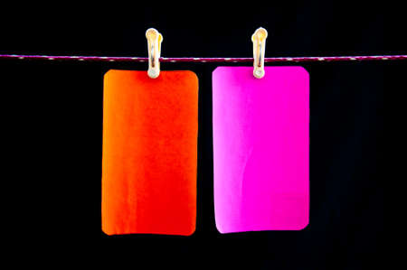 pink and orange hang paper on black backgroundの写真素材