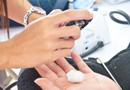 nurse use needle for blood sugar test