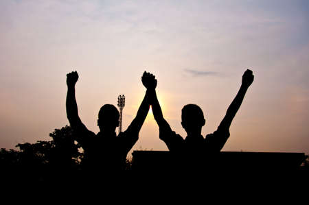 silhouette of man happy and victory in stadiumの写真素材