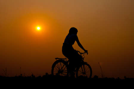 silhouette of girl happy with bicycleの写真素材
