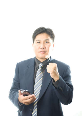 happy Asian businessman success with smartphoneの写真素材