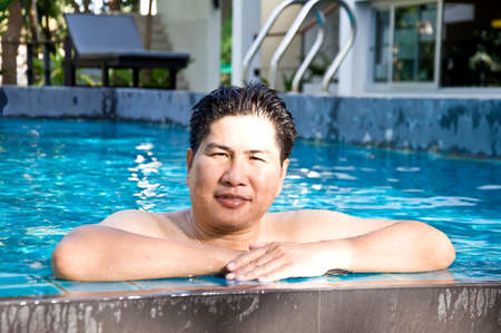 happy man in the poolの写真素材