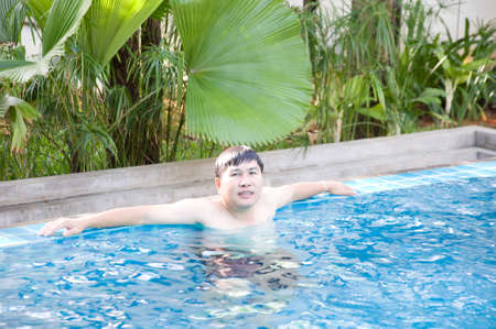 happy man in the poolの写真素材