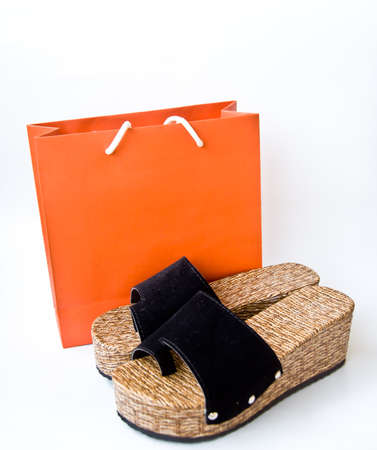 brown shoe and orange bag on white background