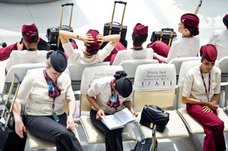 Bangkok-Thailand, October 11 unidentified Qatar Airways airhostess rest waiting for flight transportation in airport Bangkok October 11 in Bangkok Thailandのeditorial素材