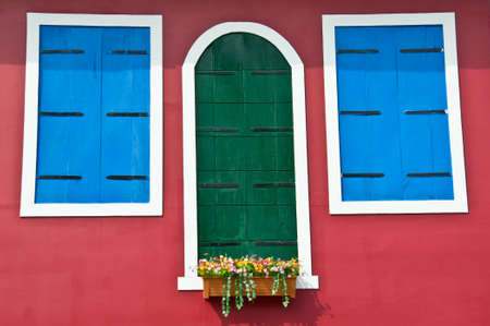 green and blue  window on red wallの写真素材