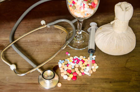 compress ball herbal with medicine and stethoscopeの写真素材