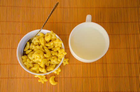 yellow cereal with milk for breakfast meal