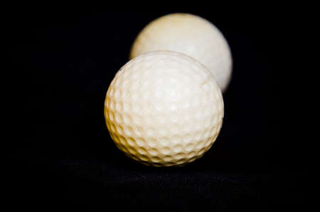 white golf ball on black backgroundの写真素材