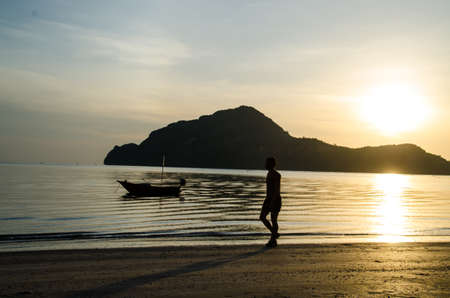 silhouette of man walking on the beachの写真素材