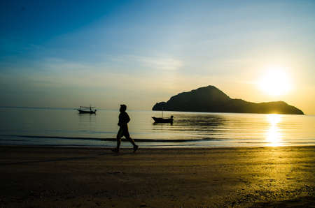silhouette of man running on the beachの写真素材