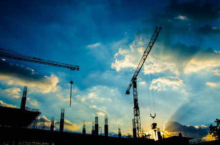 silhouette of worker working with crane for constuctionの写真素材