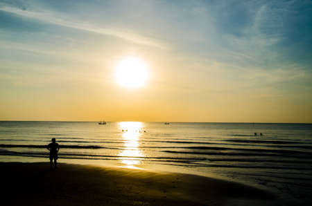 silhiuette of man looking sunrise on the beachの写真素材