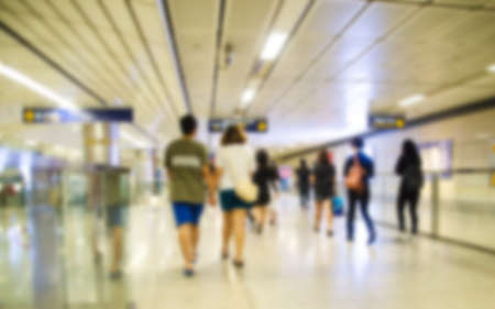 blur of people walking in tunnel to subway trainの写真素材