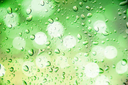 defocus of light with green  background and drop waterの写真素材