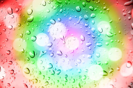 defocus of light with multicolor  background and drop waterの写真素材