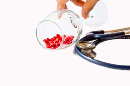 red pill in glass on white backgroundの写真素材