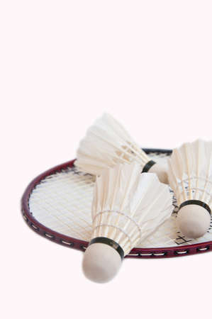 shuttlecock on racket on white backgroundの写真素材