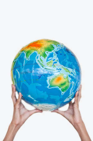 earth on children hand on white backgroundの写真素材