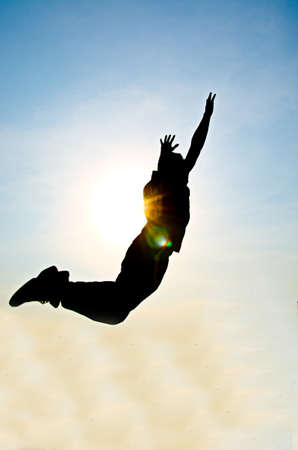 silhouette of man jumping for happy and victory