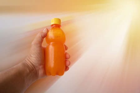 hand for orange juice with motion blur background