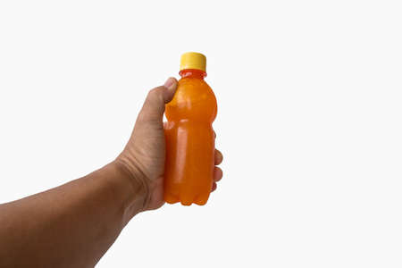 orange juice in hand on white backgroundの写真素材