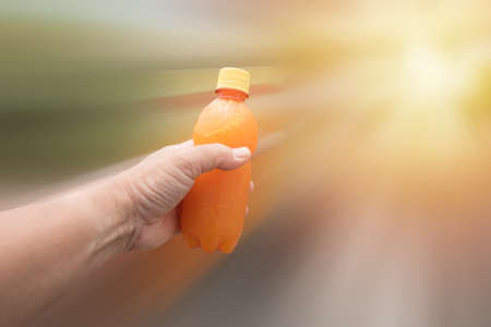 hand of orange juice for healthy の写真素材