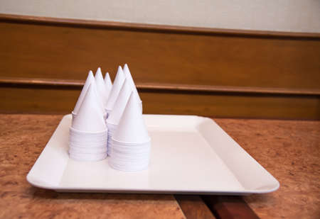 disposable paper glass for drinking warer on white backgroundの写真素材