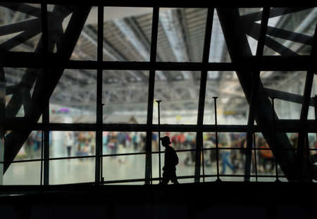 silhouette of man walking  in the airportの写真素材