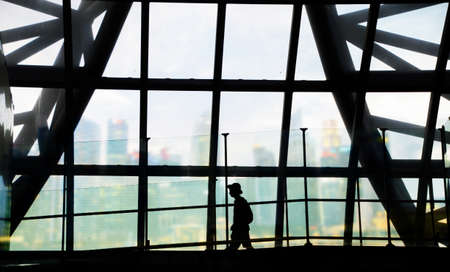 silhouette of man walking in the airport with city business backgroundの写真素材