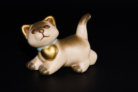 Ceramic cat isolated on black backgroundの写真素材