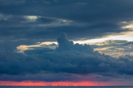 Pink sunrise and dark clouds over the adriatic sea