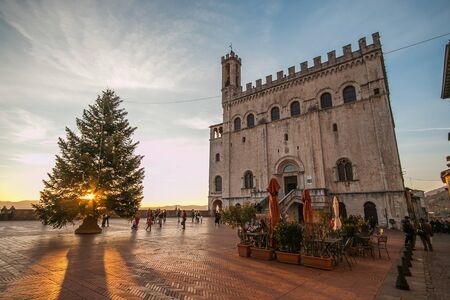 GUBBIO, ITALY - DECEMBER 18, 2016: Beautiful square of Gubbio at sunset with christmas treeのeditorial素材