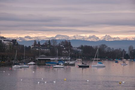 ZURICH, SWITZERLAND - DECEMBER 11, 2016: Romantic sunset on Zurich lake with alps in backgroundのeditorial素材