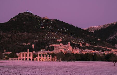 Winter romantic sunset on Gubbio. Medieval town with snow in Italyの写真素材