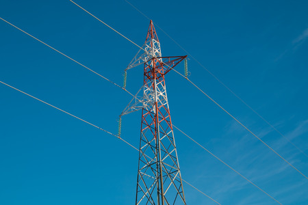 Electricity pylon against the blue sky