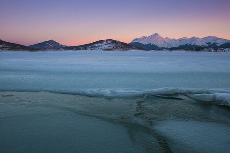 Winter cold sunset in the frozen Campotosto lake, Abruzzoの写真素材