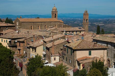 Sunny day over the roofs of the old town. Montalcino, Italyの写真素材