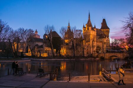 BUDAPEST, HUNGARY - JANUARY 1, 2020: Sunset over Vajdahunyad Castle in the City Park of Budapest,...