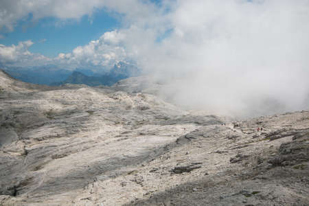 Panoramic view of plateau of Pale with fog in the Italian Dolomites, San Martino di Castrozza,...