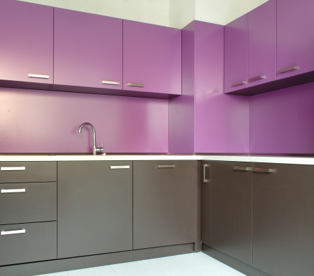 Newly fitted modern kitchen in purple and brownの写真素材