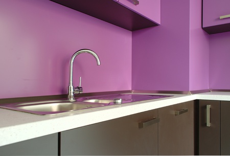 Newly fitted modern kitchen in purple and brownの写真素材