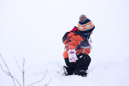Children playing in the snowの写真素材