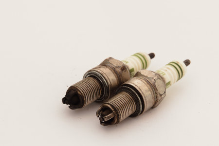 Used Spark Plug Set on White Background â€“ Old Car Engine Ignition Parts