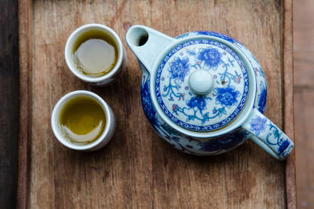 Tea pot and cups on wooden trayの写真素材