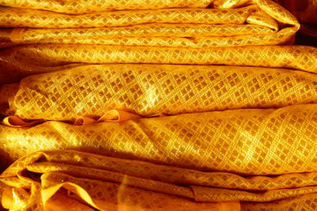 Golden color ancient textile texture for backgroundの写真素材