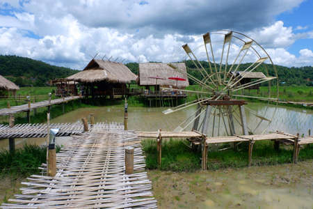 Asian house and water wheel in Southeast Asia.の写真素材