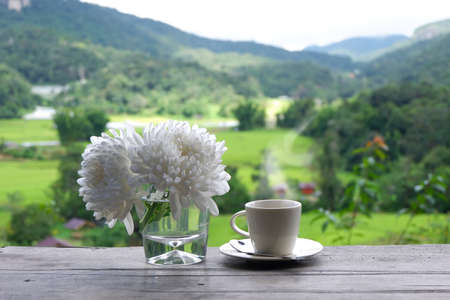 Hot coffee in green nature background.